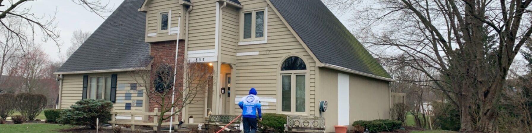 Pressure washing a residential home exterior in Fishers, IN