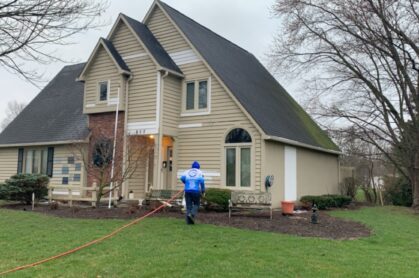 Pressure washing a residential home exterior in Fishers, IN