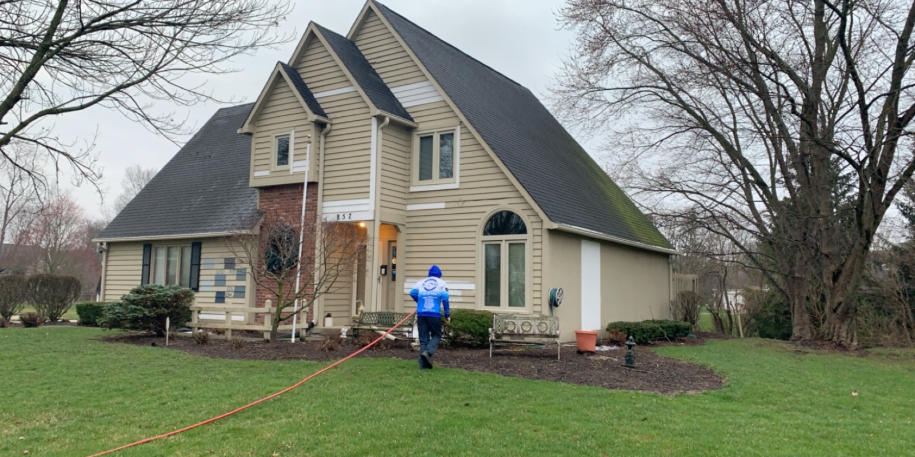 Pressure washing a residential home exterior in Fishers, IN