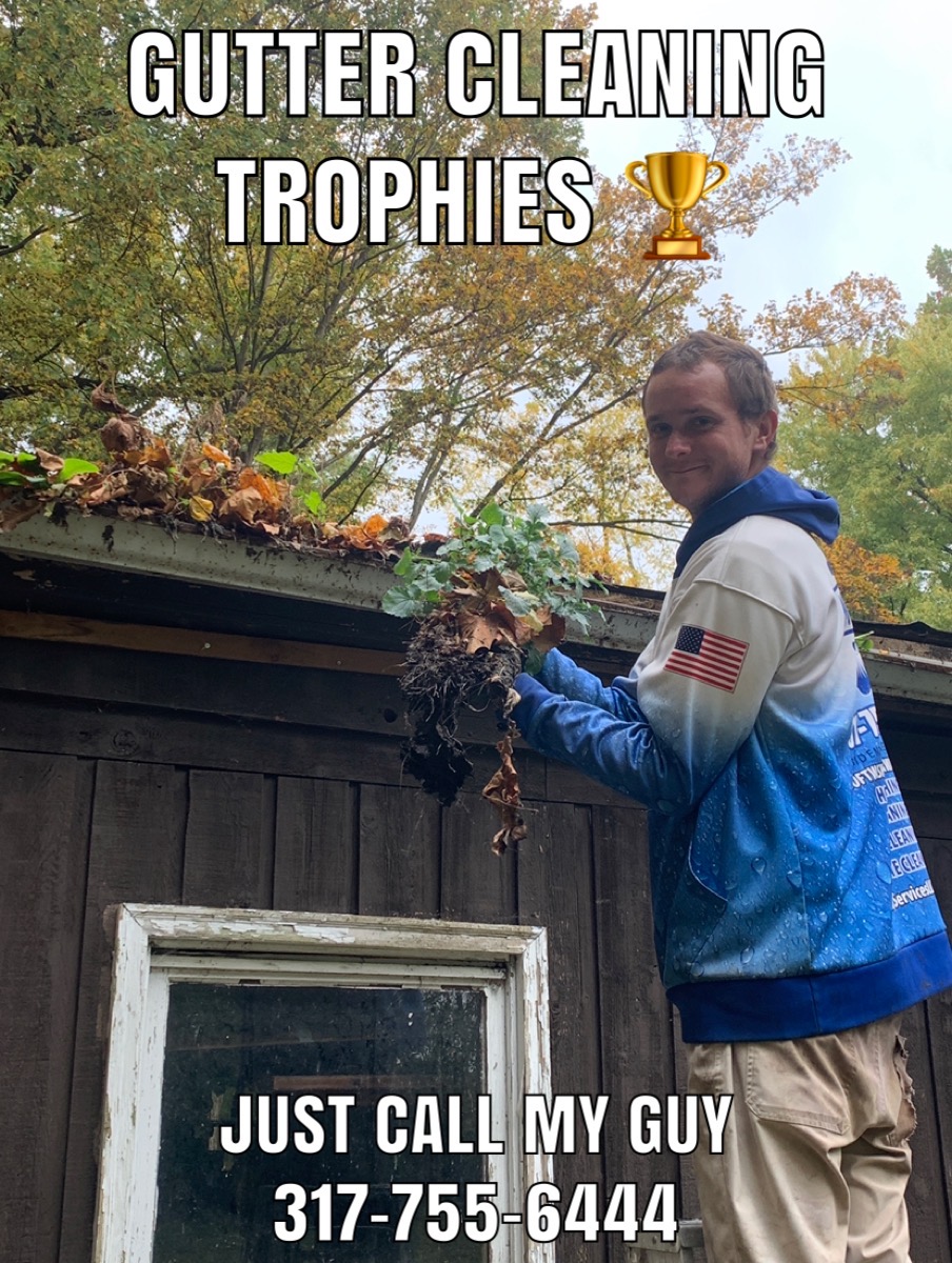 Gutter cleaning with fallen leaves on a Fishers home in autumn