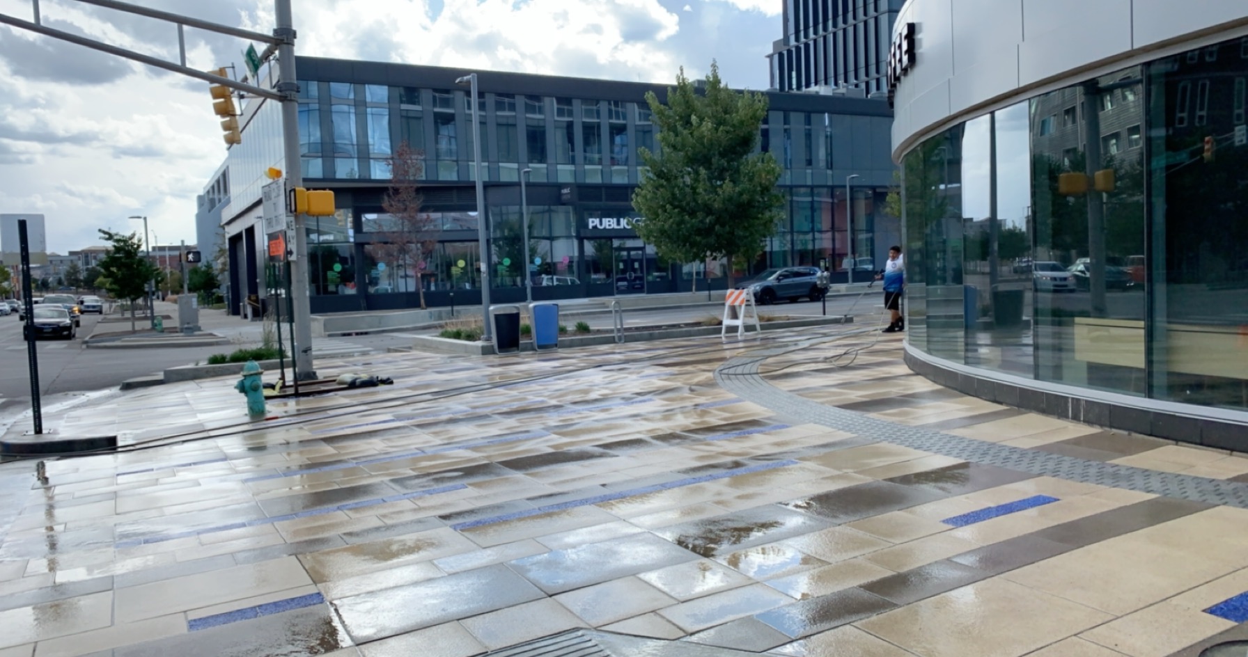Commercial sidewalk or entryway being cleaned with snow or salt residue visible